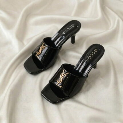 Ruby Mule Heel – Black glossy mule heel with gold-tone detailing and square-toe design.