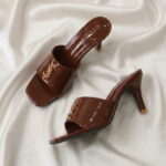 Ruby Mule Heel – Chocolate glossy mule heel with gold-tone detailing and square-toe design.