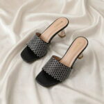 Midnight Crystal Heel – Black crystal-studded mule heels with a sculpted metallic heel.