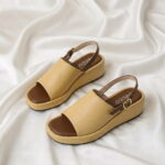 Aura Wedge Sandal – Master with open-toe design, slingback strap, and wedge sole.