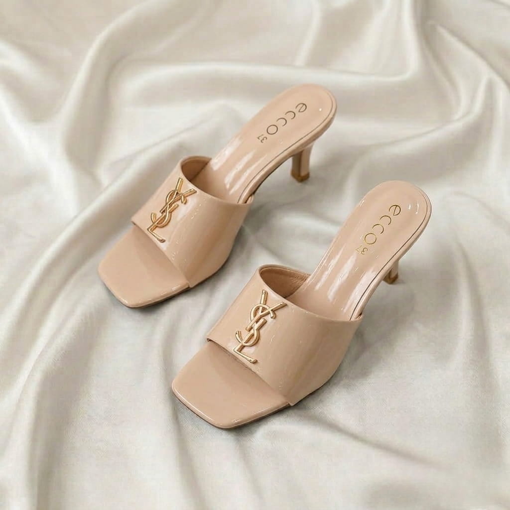Ruby Mule Heel – Beige Ruby Mule Heel – Beige glossy mule heel with gold-tone detailing and square-toe design.